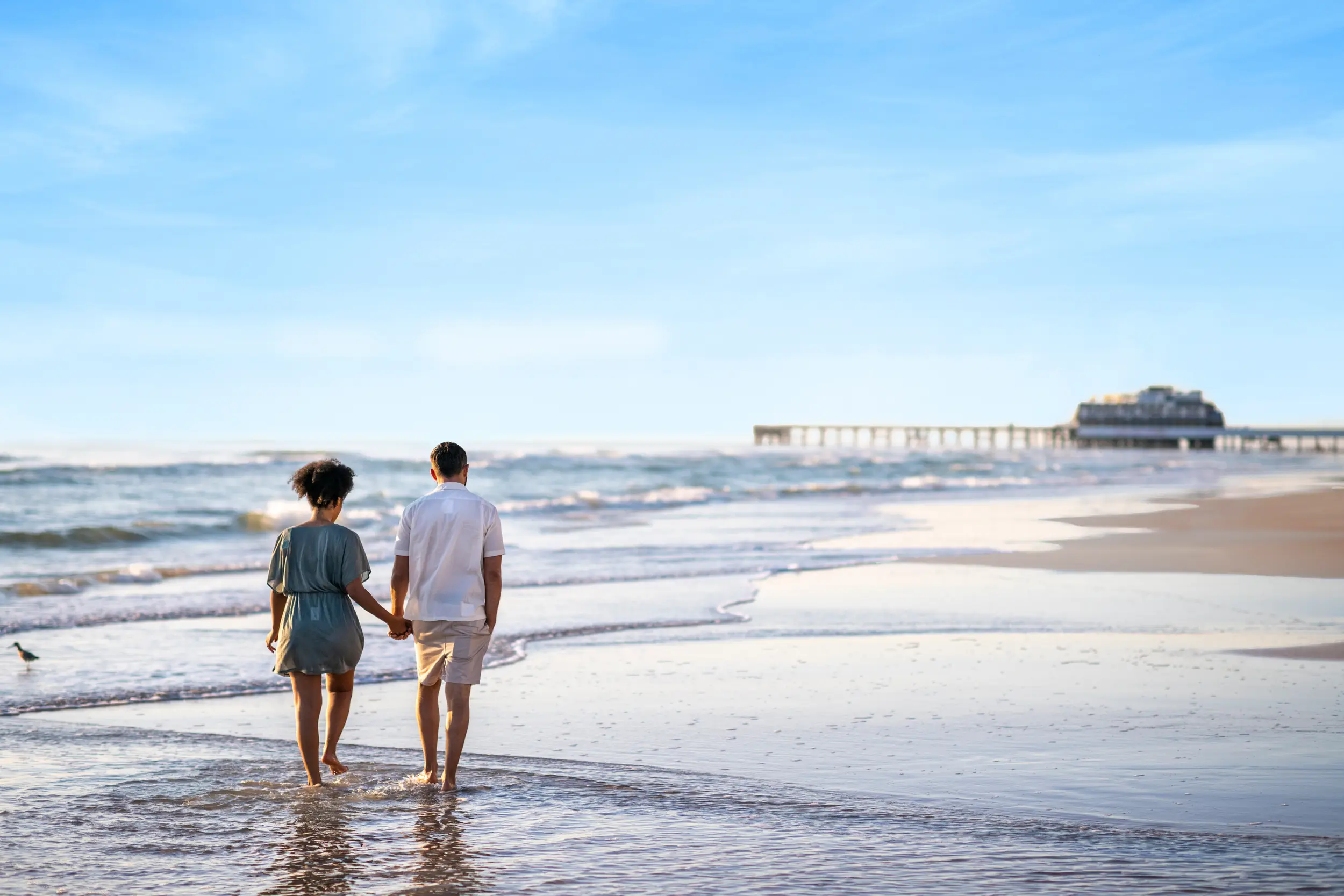 couple holding hands on beach