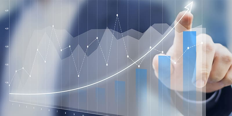 Someone pointing at the upward trajectory of a graph