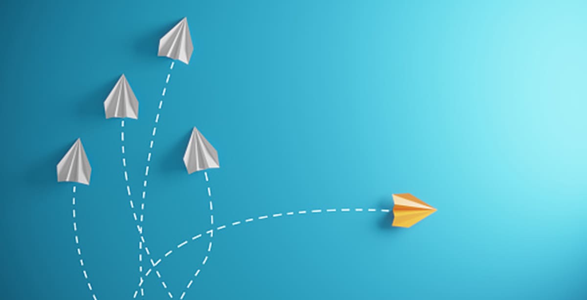 Paper airplanes flying in different directions