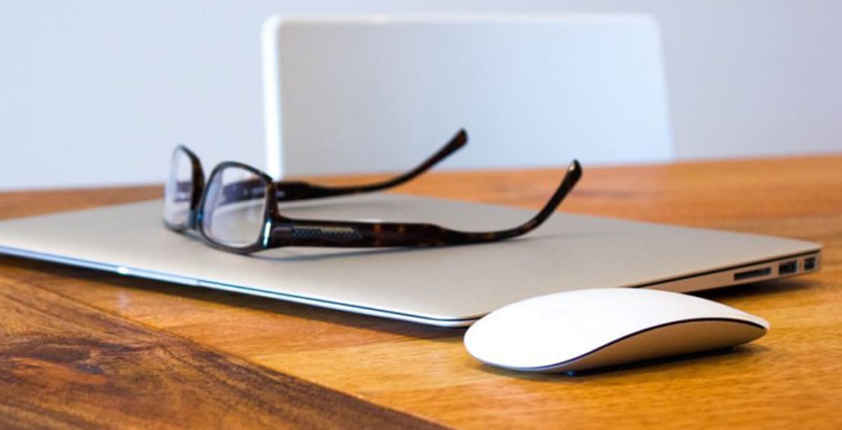 Pair of glasses sitting on a laptop