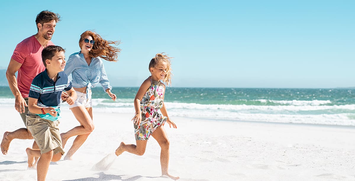 Family running on the beach