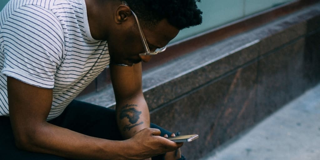 Man sitting and using his phone
