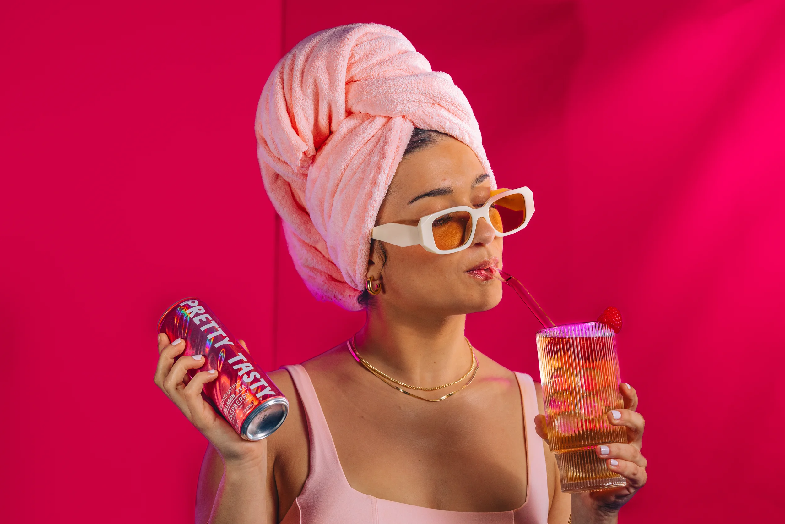 girl with towel on head drinking from a glass