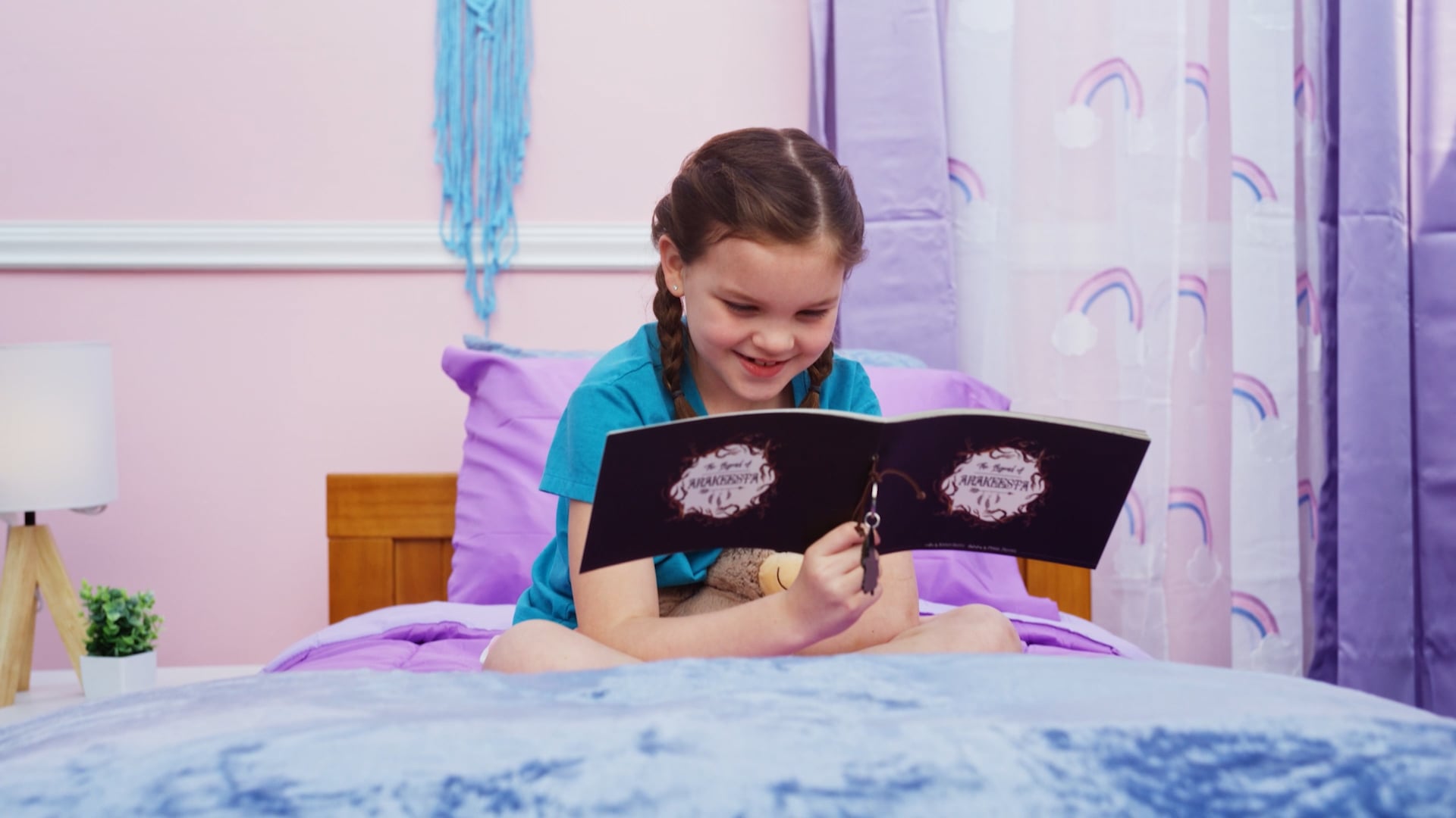 girl reading book on bed