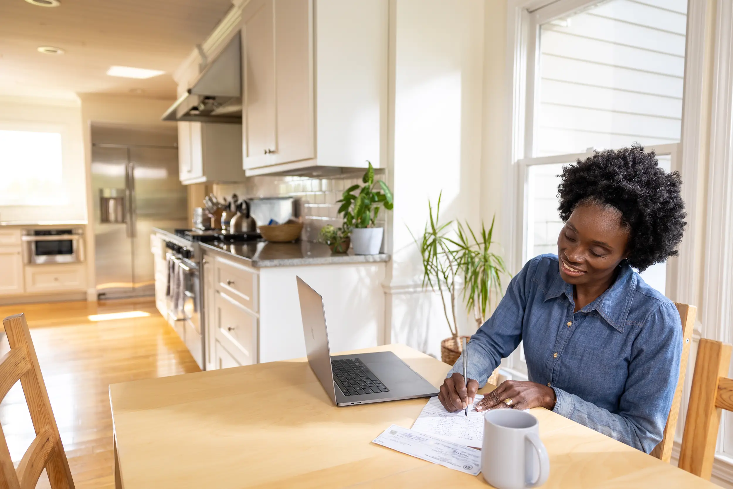 lady at table with laptop and papers