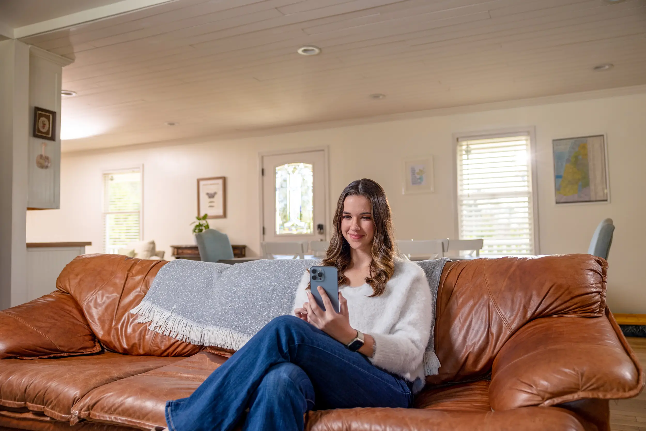 girl on couch holding phone