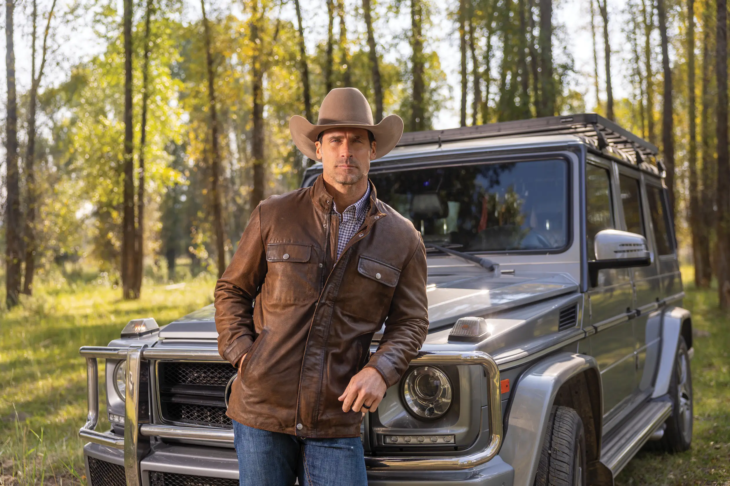 man leaning on G-wagon