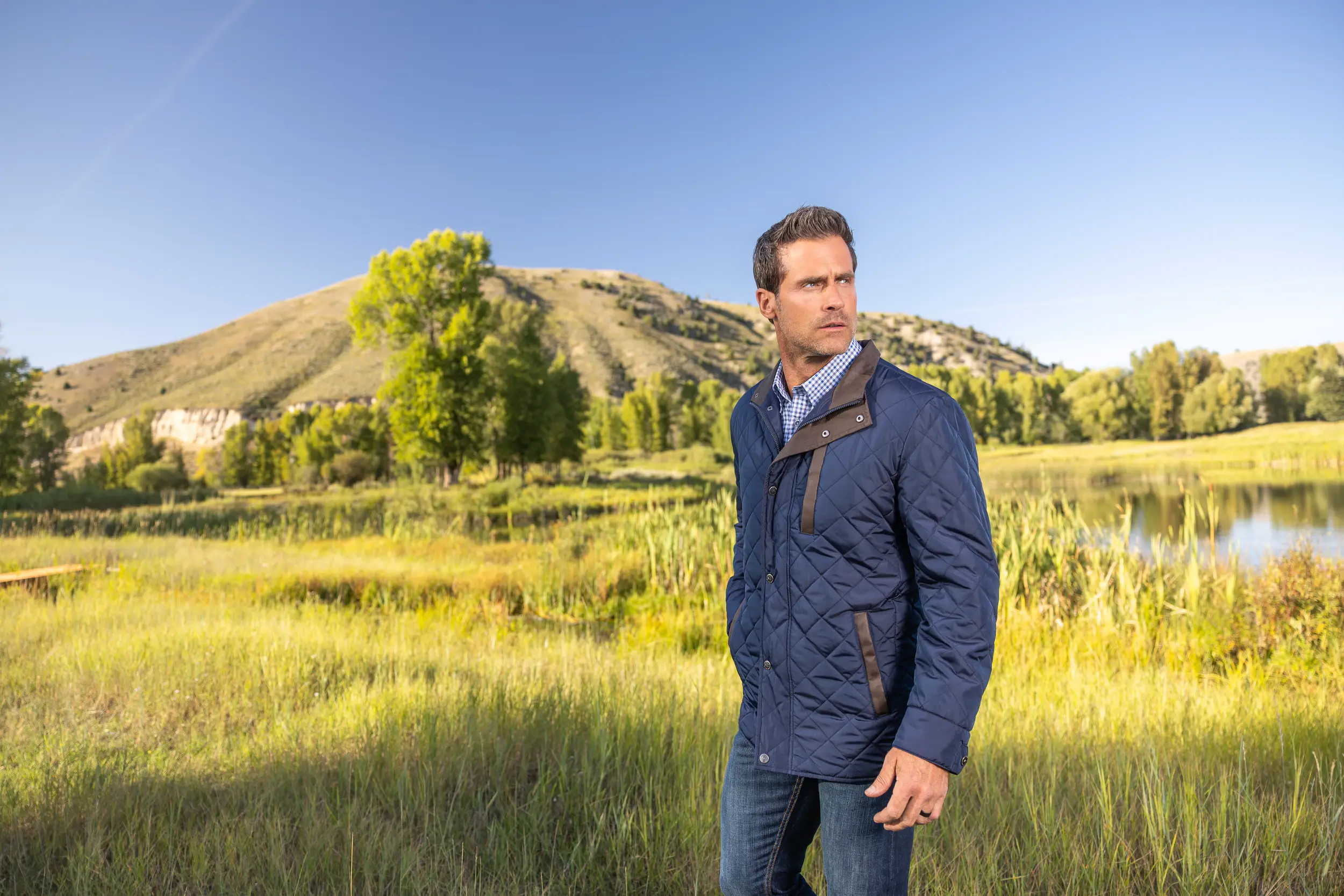 man with quilted jacket and mountains