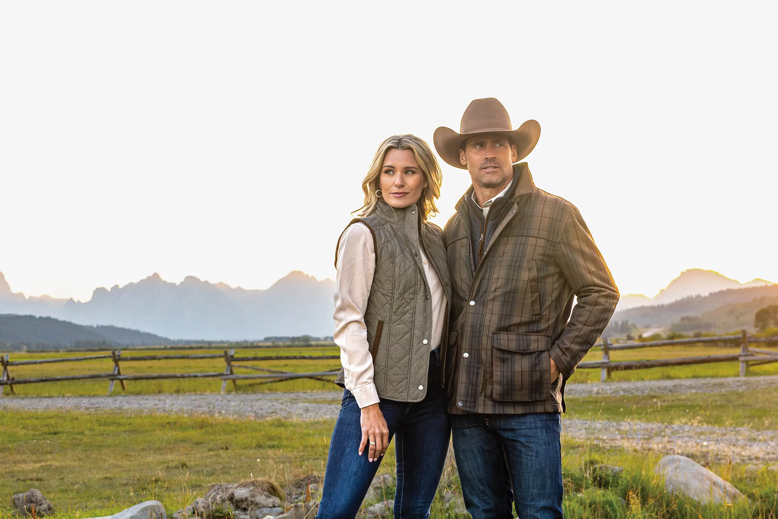 Couple smiling with mountains in the background