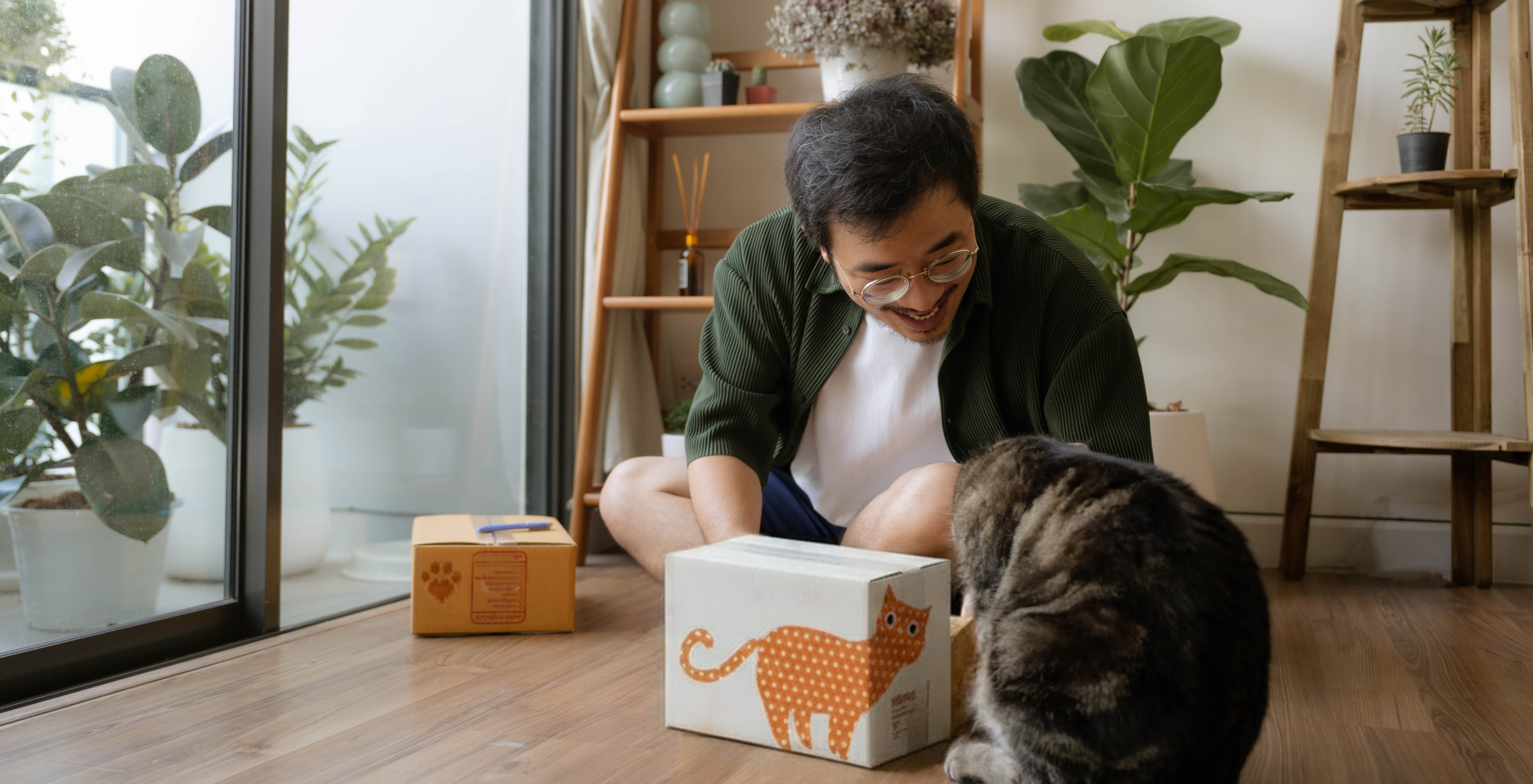 man with cat and box