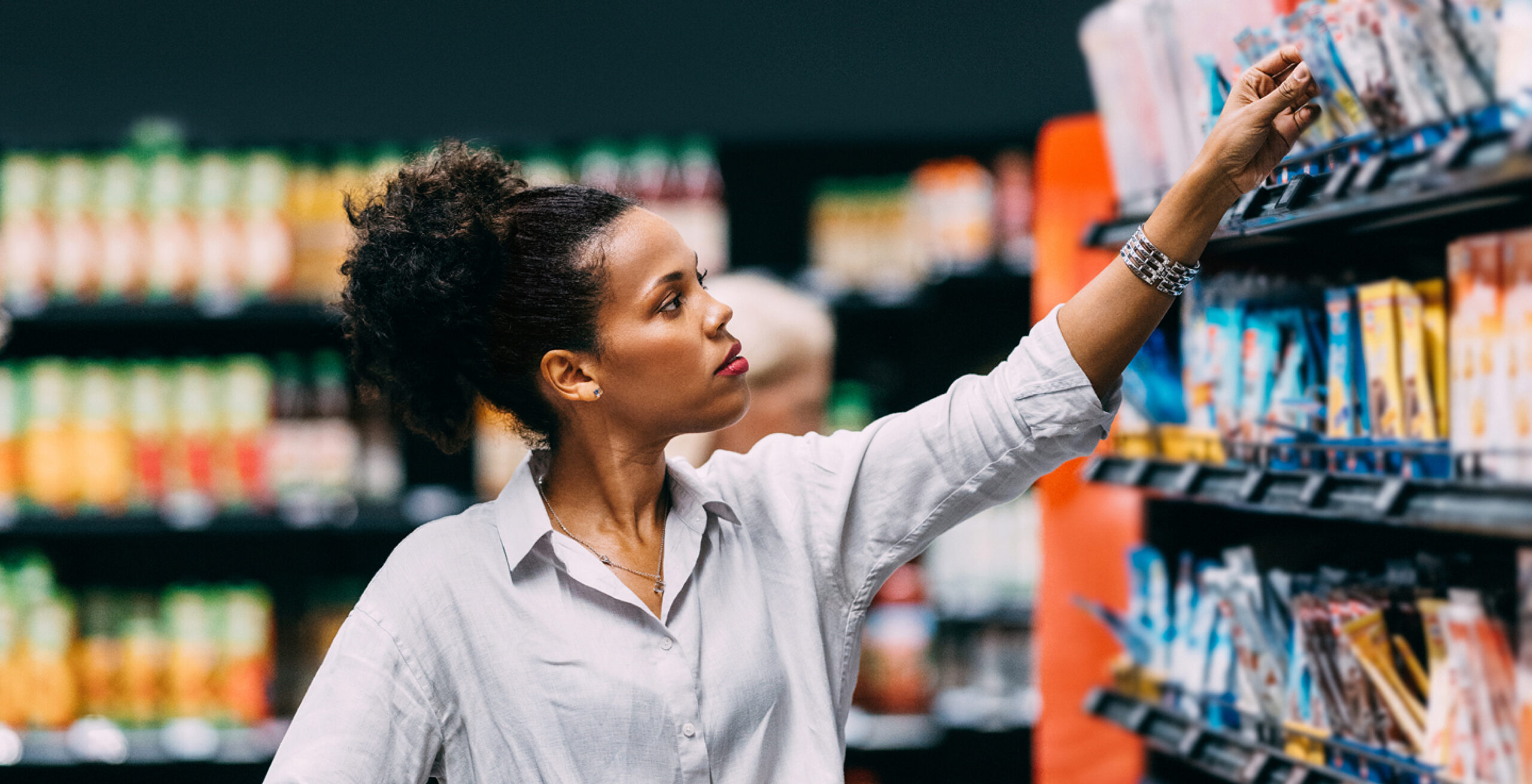 woman reaching for item on shelf