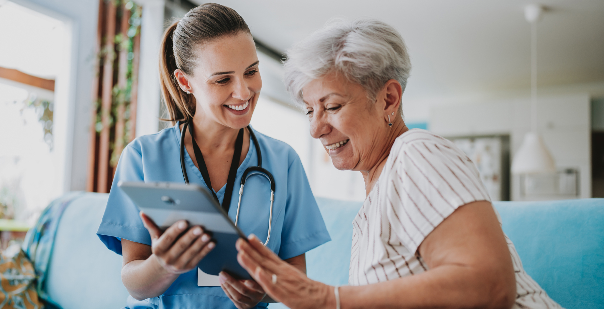 Doctor looking at ipad with patient