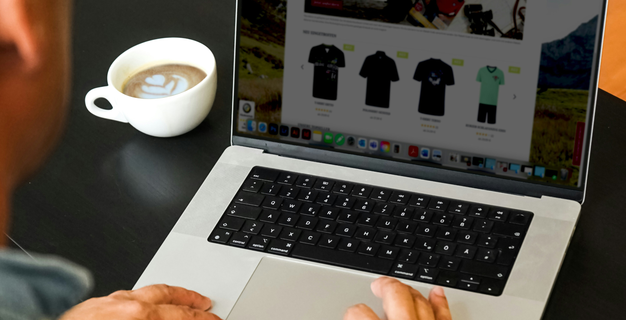 man scrolling apparel on laptop